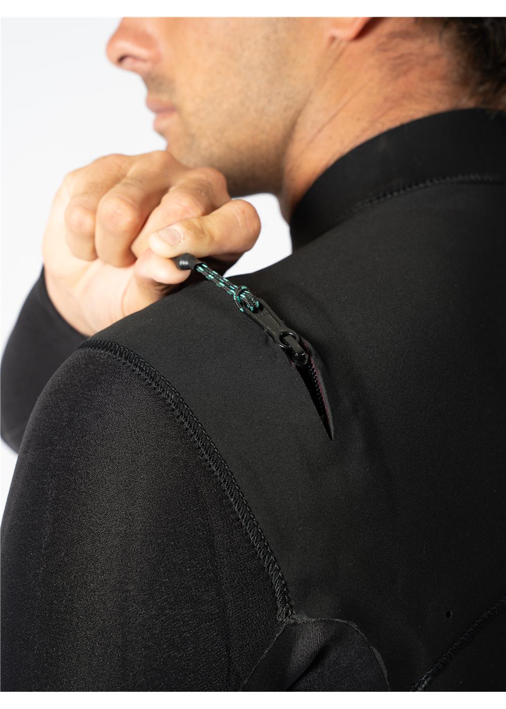 Close-up of Vissla wetsuit U-zip being adjusted on the shoulder.