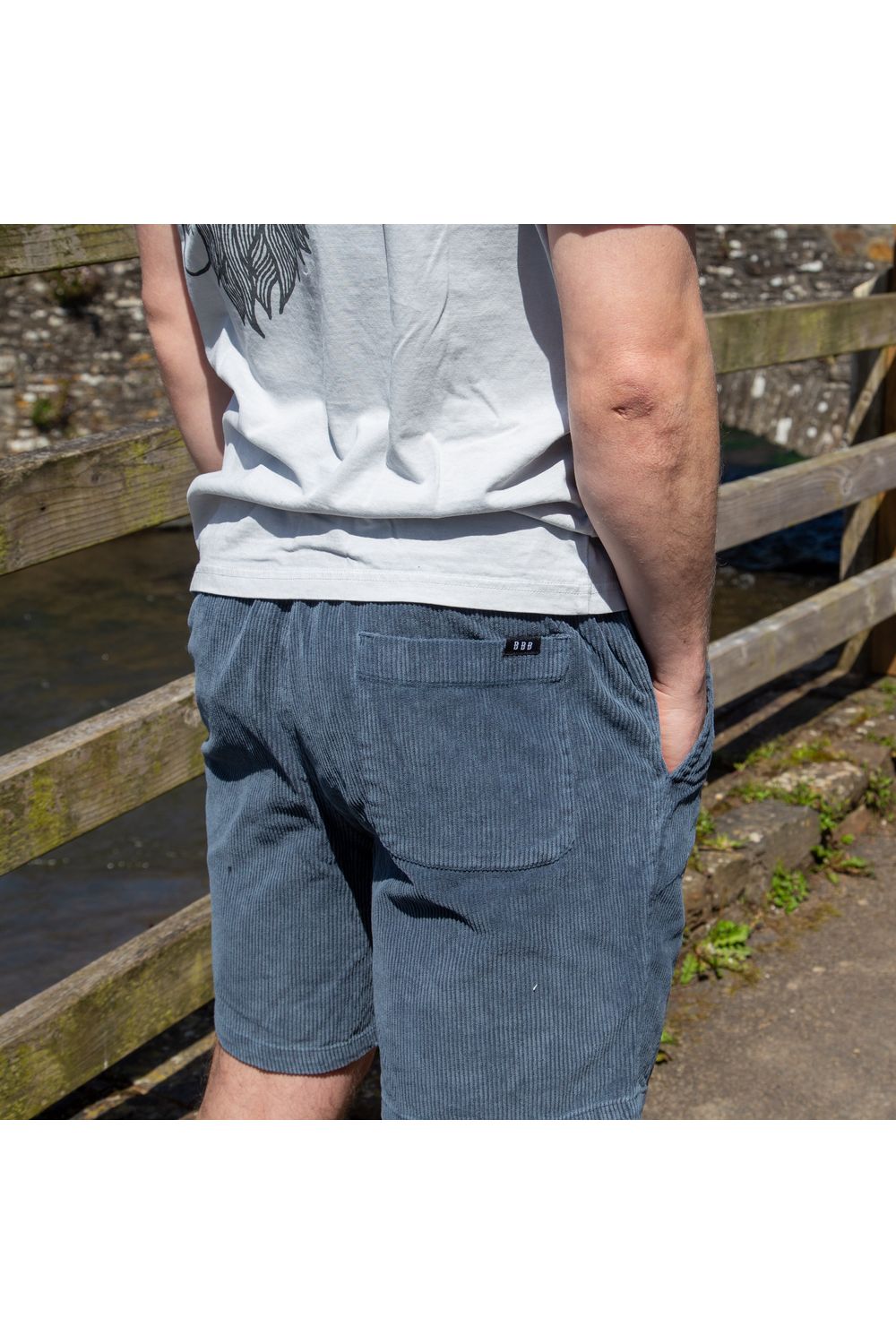 Bamboobay Cord Shorts in Navy on model showing back with hands in pockets 