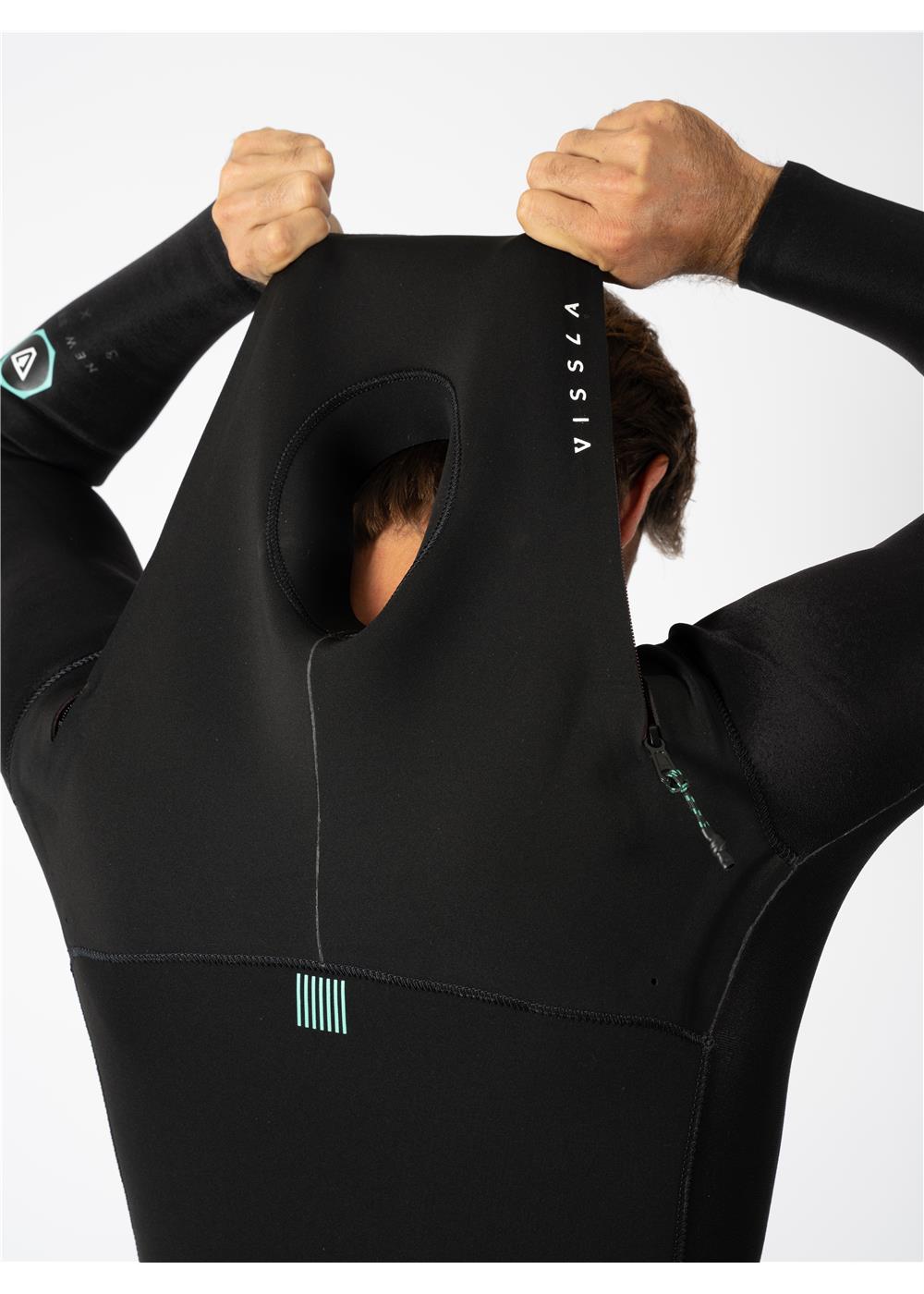 Man pulling on the hood of Vissla New Seas wetsuit with U-zip design.